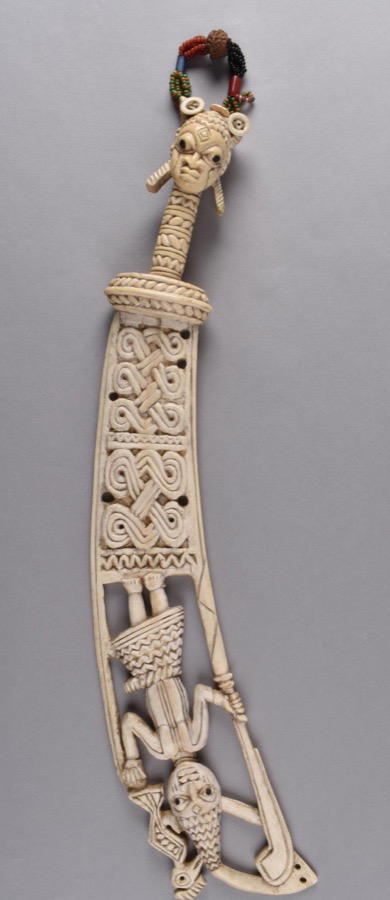 Ifa sword, ritual sword carved in ivory, the handle terminating in a head with a string of beads