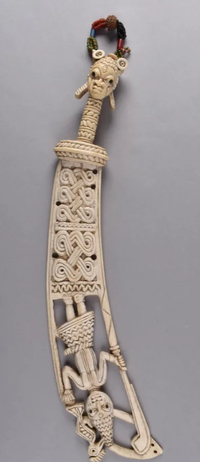 Ifa sword, ritual sword carved in ivory, the handle terminating in a head with a string of beads