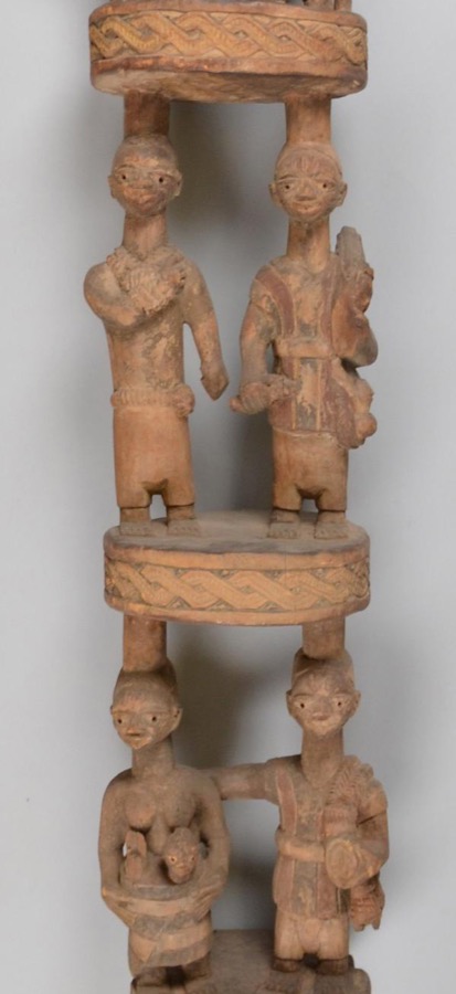 Veranda post carved by Olowe of Ise for the palace of the Ogoga of Ikere, showing a seated king with a tall crowned queen standing behind him